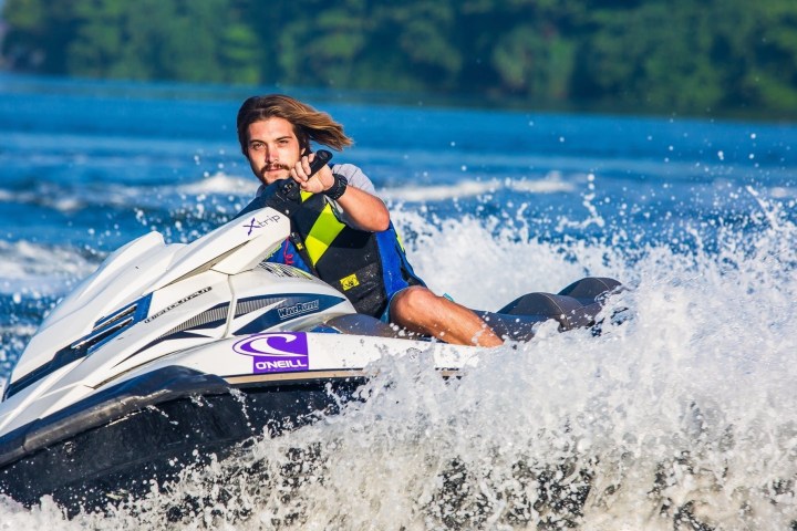 a man riding a wave on a surf board on a body of water